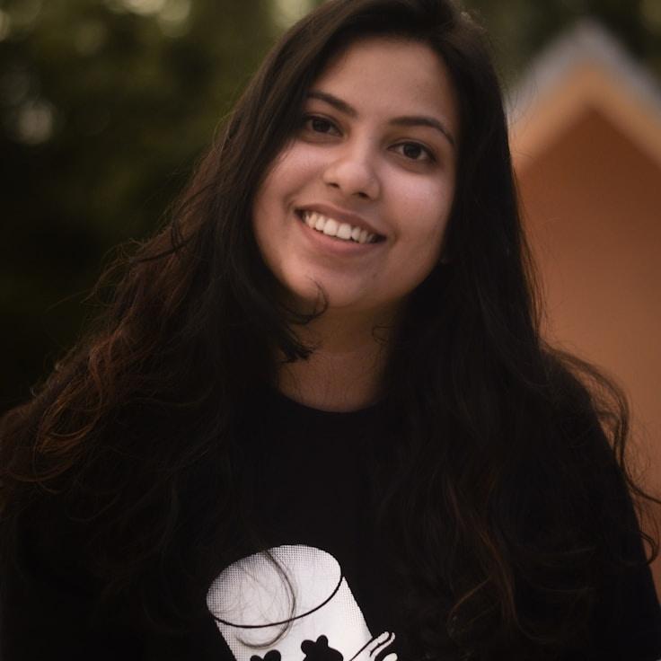 Avery Chen, Lead Design Curator at Matrix Grain Dawn, reviewing corporate floral arrangements